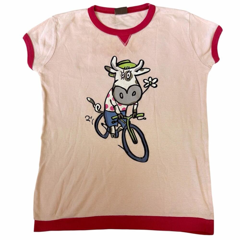 Mad's pink cotton baby tee with cartoon cow riding a bicycle graphic